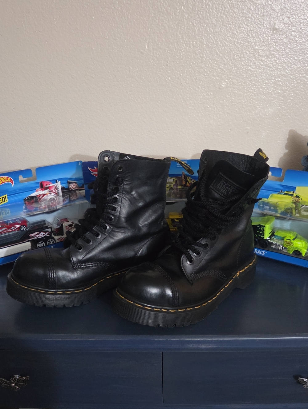 Dr. Martens steel toe black leather lace-up combat boots.